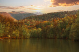 Fototapeta Na ścianę - Beautiful autumn landscape with lake and trees at the sunset. 
