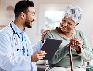 It was nothing to worry about. Shot of a young doctor sharing information from his digital tablet with an older patient.