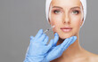 © Acronym - Doctor injecting in a beautiful face of a young woman. Plastic surgery concept.