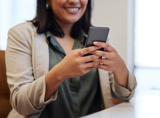 Canvas Print - Every app makes an impact towards growing my business. Closeup shot of an unrecognisable businesswoman using a cellphone in an office.