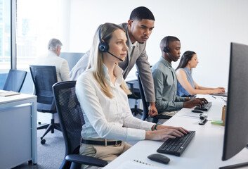 Poster - Tackling customer queries as a team. Shot of a businessman and businesswoman using a headset and computer while working in a modern office.