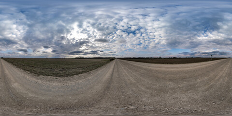 Wall Mural - gravel road with clouds on overcast sky as spherical 360 hdri panorama in equirectangular seamless projection, use as sky replacement in drone panoramas, game development as sky dome or VR content