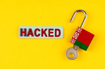 Poster - On the yellow surface is an open lock with a key and a sticker with the inscription - hacked