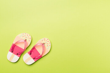 Wall Mural - Bright flip flops on color background, top view