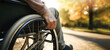 closeup of disabled person riding in wheelchair at park. disability insurance. generative AI