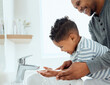 © K.A./peopleimages.com - Wash them thoroughly. Shot of an adorable little boy washing his hands with the help of his father at home.
