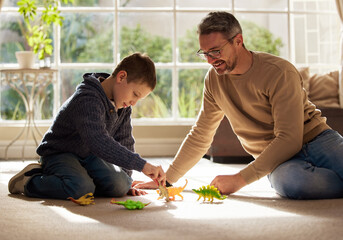 Wall Mural - Can I play too. Shot of a father and son bonding on the lounge floor at home.