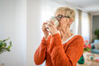 © Miljan Živković - Close up portrait of one senior woman with short hair drink