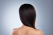 © Talia M/peopleimages.com - Rear view of brunette woman posing with her hair over her shoulder. Young mixed race woman with healthy smooth straight hair
