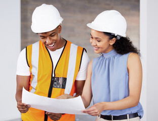 Wall Mural - Im pleased with these. Shot of two young contractors standing inside together and looking at building plans.