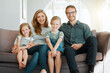 © K.A./peopleimages.com - This is our little family. Shot of young family sitting on the sofa at home together and bonding.