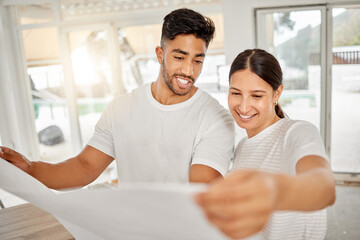Poster - This is going to look so good. Shot of a young couple standing together and looking at building plans for their home.