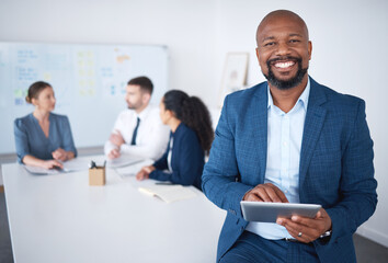 Aufkleber - Portrait of smiling confident african american businessman in boardroom using digital tablet. Diverse group of businesspeople in meeting and working behind black manager. Browsing online on technology
