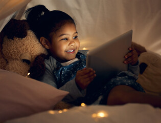 Canvas Print - She just had to watch one last episode. Shot of a little girl using a digital tablet late at night at home.