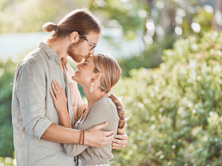 Wall Mural - Devoted to you for life. Shot of a young couple spending time together in the garden at home.