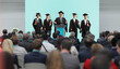© Ljupco Smokovski - Professor and graduate students standing on a podium in front of people