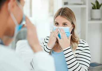 Poster - True health care is vital. Shot of two people putting on a mask in a clinic.