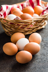 Sticker - Whole chicken eggs on black table.