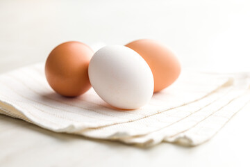 Sticker - Whole chicken eggs on kitchen napkin.