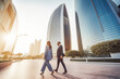 © VisualProduction - Business man and woman walking in business district in Dubai. Big city modern lifestyle, working in busy district. Generative AI
