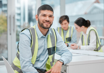 Poster - You can trust us with your building project. Cropped portrait of a handsome young male construction worker sitting in a meeting with his colleagues.