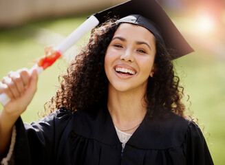 Poster - I earned this. Portrait of a young woman holding her diploma on graduation day.