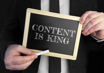 Poster - A businessman holds up a chalkboard with text CONTENT IS KING