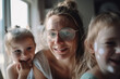 © wetzkaz - mature woman with dirty glasses playing with two girls daughters. Generative AI