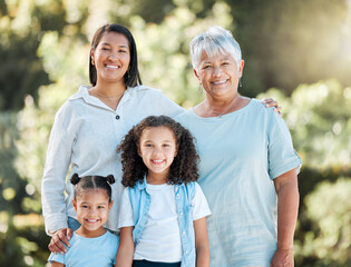 Wall Mural - Where there is family, there is love. Shot of two little girls standing outside with their mother and grandmother.