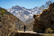 © juliovazquez - Woman hiking in Vereda de la Estrella. Peaks of Sierra Nevada National Park in the background (Alcazaba, Mulhacén)