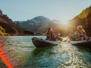 Wall Mural - A group of friends enjoying fun and kayaking exploring the calm river, surrounding forest and large natural river canyons during an idyllic sunset.