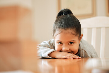 Wall Mural - Shell easily steal your heart. Shot of a little girl relaxing at the table at home.