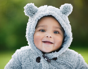 Wall Mural - Dont you just wanna cuddle this cutie. Portrait of an adorable baby boy wearing a furry jacket with bear ears outdoors.