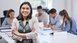 © Michael C/peopleimages.com - A team of hard workers. Shot of a young businesswoman standing with her arms crossed in an office at work.