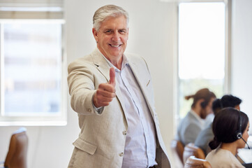 Poster - Leave the hard work to my team. Shot of a mature businessman standing in the office and showing a thumbs up.