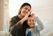 © K Abrahams/peopleimages.com - A mother and daughter bond is like no other. Shot of a young mother and son making a heart gesture with their hands at home.