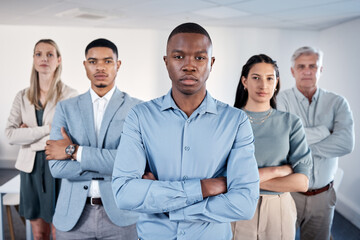 Poster - Its about having the drive to succeed. Portrait of a confident young businessman standing with his arms crossed in an office with his colleagues behind him.