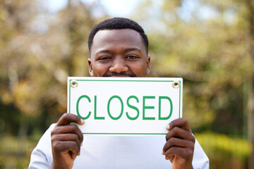 Poster - End of business. Shot of a young woman holding a closed outside.