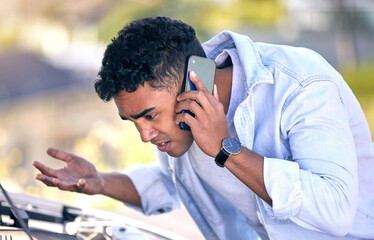 Poster - I cant see anything like that. Cropped shot of a handsome young man on the phone with roadside assistance after suffering a vehicle breakdown.