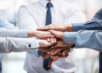 Poster - a prayer in corporate. shot of a group of business people with their hands stacked.