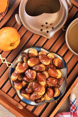 Wall Mural - Roasted salted broad beans on a plate on wooden table