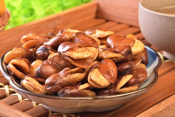 Wall Mural - Roasted salted broad beans on a plate on wooden table