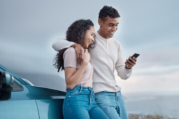 Sticker - Lets see what social media has to say. Shot of a young couple using a phone on a road trip together.