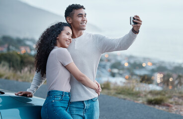 Poster - Lets make memories everywhere we go. Shot of a young couple taking a selfie while on a road trip together.