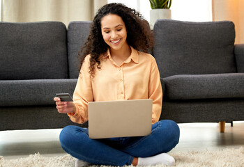 Wall Mural - You dont just work to pay bills, spoil yourself. Shot of a woman holding a credit card while using her laptop.