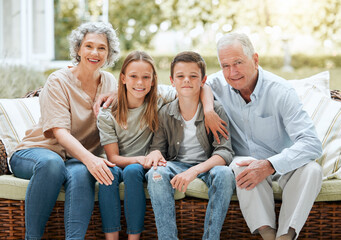 Poster - When we count our blessings, we count our grandchildren twice. Shot of a senior couple sitting outside with their two grandchildren.