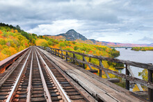 Fall Scene On Train Trestle With Mountain In Foreground