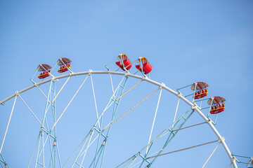 Wall Mural - Ferris wheel, booths against the blue sky.