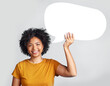 © Nicholas Felix/peopleimages.com - Speech bubble, portrait and happy woman in studio with mockup, message and space on grey background. Banner, poster and African female with social media, news or announcement on isolated billboard