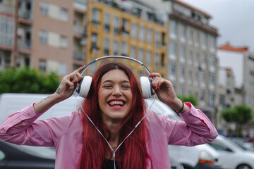 Wall Mural - funny young woman with headphones on the street